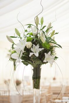 a vase filled with white flowers on top of a table