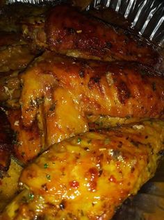 some chicken is sitting in tin foil on the table and ready to be cooked or eaten