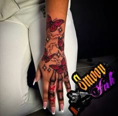 a woman's hand with butterflies on it and the words simply ink in front of her