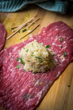 raw meat on a wooden cutting board with chopsticks