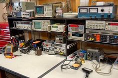 there are many electronic equipment on the table in this room, including two radio sets and several other electronics