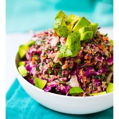 a white bowl filled with coleslaw, avocado and cilantro