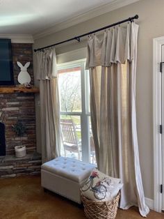 a living room with a couch, chair and television on top of a fireplace mantel