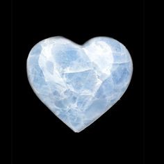 a heart shaped piece of ice on a black background in the shape of a rock