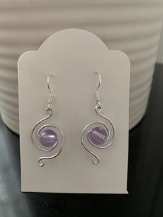 a pair of earrings sitting on top of a table