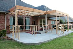 a house that is under construction in the day time and has wood framing around it