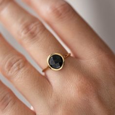 Natural black onyx 14K solid gold ring for women. A delicate black onyx gemstone ring, ideal for stacking for every woman who loves elegance. An excellent choice for anniversary gift or Valentine's gift for her by Kyklos. 100% handcrafted with love! D E T A I L S ● Metal: 14K solid gold, 14K white gold or 14K rose gold ● Gemstone: Black Onyx, briolette cut ● Stone Diameter: 8mm (0.31in), 10mm (0.4in) and 12mm (0.5in)  R I N G ∙ S I Z I N G For General Reference: ● we use standard US Ring Sizing Black Birthstone Jewelry For Promise Ring, Black Birthstone Rings, Black Birthstone Ring Gift, Black Birthstone Rings For Anniversary, Black Birthstone Rings For Gifts, Elegant Adjustable Onyx Rings, Black Oval Birthstone Jewelry, Minimalist Onyx Jewelry For Anniversary, Oval Black Birthstone Jewelry