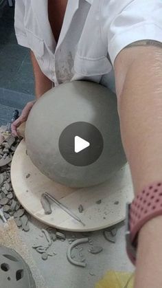 a person is making something out of clay