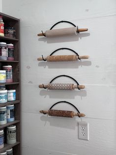 three wooden rolling wheels are hanging on the wall