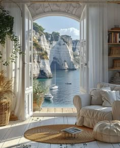 a living room with an open door leading to the sea and boats in the water