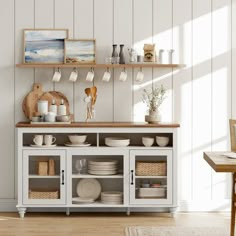 a dining room table with plates and bowls on it, next to a wall mounted shelf