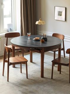 a dining room table with four chairs around it