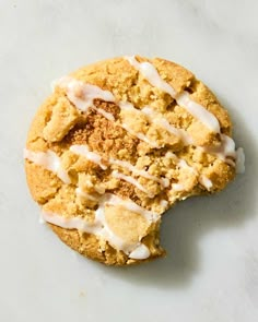 a cookie with white icing and crumbs on it