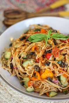 a white bowl filled with pasta and vegetables