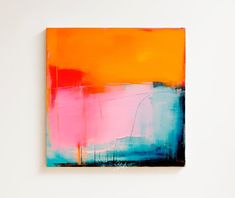 an orange and blue painting on a white wall