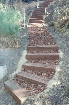 there is a set of steps that are made out of wood and mulch on the ground