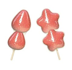 three strawberry shaped lollipops sitting on top of each other