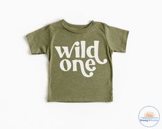 Wild One Shirt ------DETAILS------ Design made with high quality vinyl, not printed! Design is heat pressed onto garment using vinyl Can be machine washed and dried For longer durability, turn inside out, wash cold and lay out to dry ------GARMENT OPTIONS------ --Bella + Canvas-- Super Soft! 100 % combed and ring spun cotton Grey 90% combed and ring spun cotton and 10% polyester 100% No Sweatshops & Eco-Friendly ----- PROCESSING TIME ----- If needed by a certain time please contact us to see if Wild One Birthday Shirts For Family, Unisex Pre-shrunk T-shirt For First Birthday, Green Graphic Print T-shirt For First Birthday, Green Custom Print T-shirt For Birthday, Green T-shirt With Letter Print For First Birthday, Casual Pre-shrunk T-shirt For First Birthday, First Birthday Short Sleeve T-shirt With Text Print, First Birthday T-shirt With Text Print, Short Sleeve T-shirt With Text Print For First Birthday