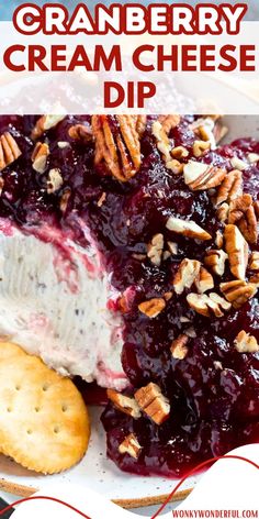 a close up of a plate of food with crackers and cranberry cream cheese dip