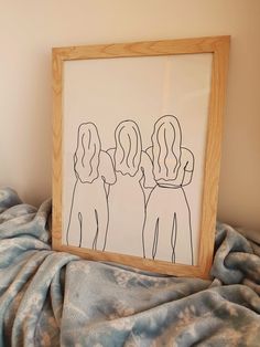 a wooden frame holding a drawing of three people