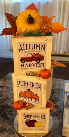 a three tiered cake decorated with pumpkins and fall leaves on it's sides