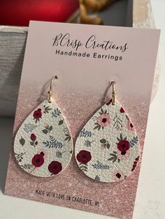 Celebrate the vibrancy of spring with these Floral Earrings. Crafted from faux leather in a teardrop shape, these small earrings feature a delightful combination of colorful flowers, making them the perfect accessory to add a touch of floral elegance to your summer style. Each pair is made for sensitive ears with hypoallergenic and nickle free hooks and a secure backing. Spring Trendy Teardrop Earrings, Trendy Teardrop Earrings For Spring, Spring Adjustable Teardrop Earrings, Spring Gift Teardrop Dangle Earrings, Spring Teardrop Earrings As A Gift, Spring Teardrop Earrings With Ear Wire, Teardrop Earrings With Ear Wire For Spring, Earrings Teardrop, Faux Leather Earrings