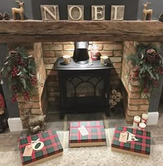 a fireplace decorated for christmas with stockings and candles