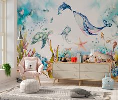 a child's room with a wall mural featuring sea animals and fish, including dolphins