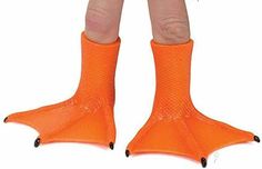 the legs and feet of a child wearing an orange pair of socks with black tips