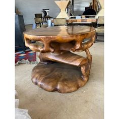 a wooden table sitting on top of a floor next to a chair in a room