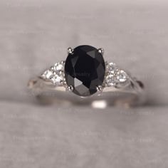 a black and white diamond ring with diamonds on it