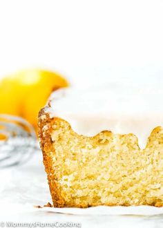 a piece of cake with icing sitting on top of it next to an orange