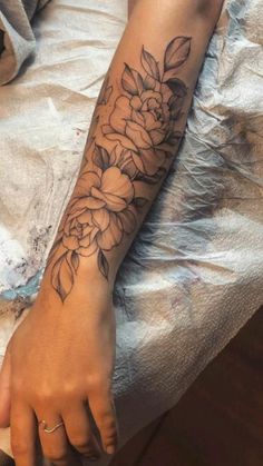 a person with a flower tattoo on their arm