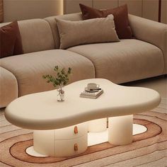 a white coffee table sitting on top of a carpeted floor next to a couch