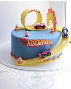 a birthday cake decorated with cars and trucks