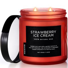 a jar of strawberry ice cream next to a candle