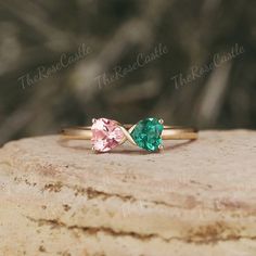 two stone ring sitting on top of a rock