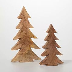 two wooden christmas trees sitting next to each other