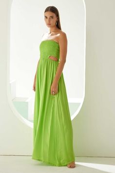 Lime green strapless dress with a solid base and cut-out smocked bodice. - Aza Fashions Green Maxi Dress With Ruched Bodice For Summer, Sleeveless Green Dress With Smocked Bodice, Green Strapless Dress For Vacation, Summer Green Maxi Dress With Ruched Bodice, Green Bandeau Dress For Spring, Green Strapless Dress With Smocked Bodice, Chic Green Strapless Sundress, Chic Green Dress With Elastic Neckline, Green Bandeau Dress For Vacation