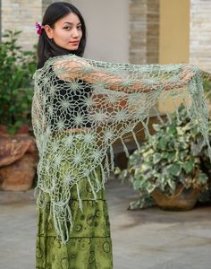 Embrace the magic of nature with the Floral Web Wrap Shawl; a hand-crocheted masterpiece adorned with intricate floral patterns and whimsical fringe, in a gorgeous seafoam green. This generously sized triangle shawl offers the perfect blend of style and comfort, effortlessly elevating your look, whether you're dancing under festival lights or savoring a cool evening outdoors. Crafted from soft, lightweight yarn, it drapes beautifully over your shoulders, providing cozy warmth without sacrificing Spring Bohemian Crochet Shawl, Handmade Bohemian Shawl For Spring, Bohemian Crochet Lace Shawl For Spring, Handmade Green Bohemian Shawl, Green Shawl For Beach, Bohemian Shawl With Crochet Lace, Spring Festival Crochet Shawl, Bohemian Crochet Lace Shawl, Green Bohemian Shawl For Festival