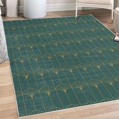 a green area rug with gold designs on it