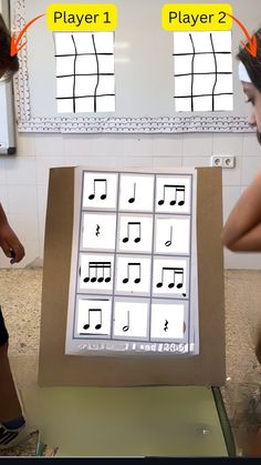 two children are playing with an interactive music board