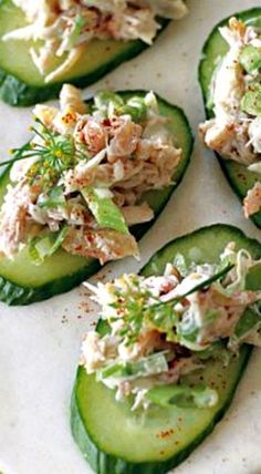 cucumbers with crab salad on them sitting on a plate