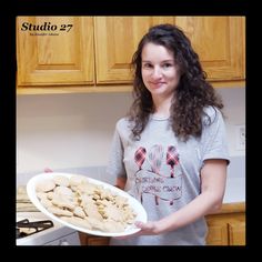 a woman holding a plate with mushrooms in it