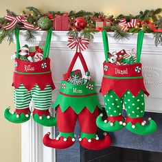 christmas stockings hanging from a mantel decorated with candy canes