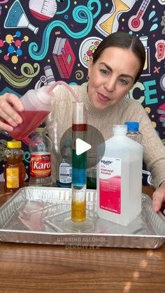 a woman is pouring liquid into a container on a tray with other bottles and condiments