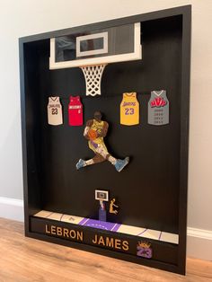 a display case with basketball memorabilia and jerseys on it