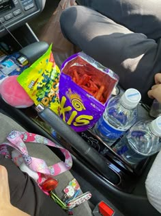 the back seat of a car filled with snacks and water