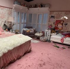 a bed room with a neatly made bed and pink carpet