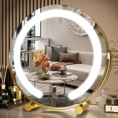 a living room scene with focus on the coffee table and large round mirror over it